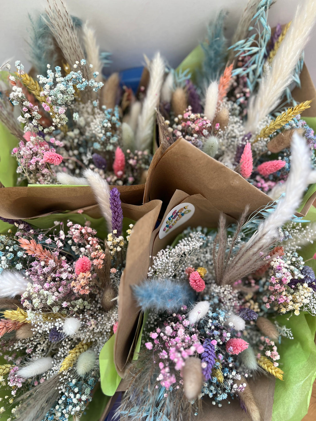 A picture of 4 dried flower bouquets in pink, lavender and white pastel colours 