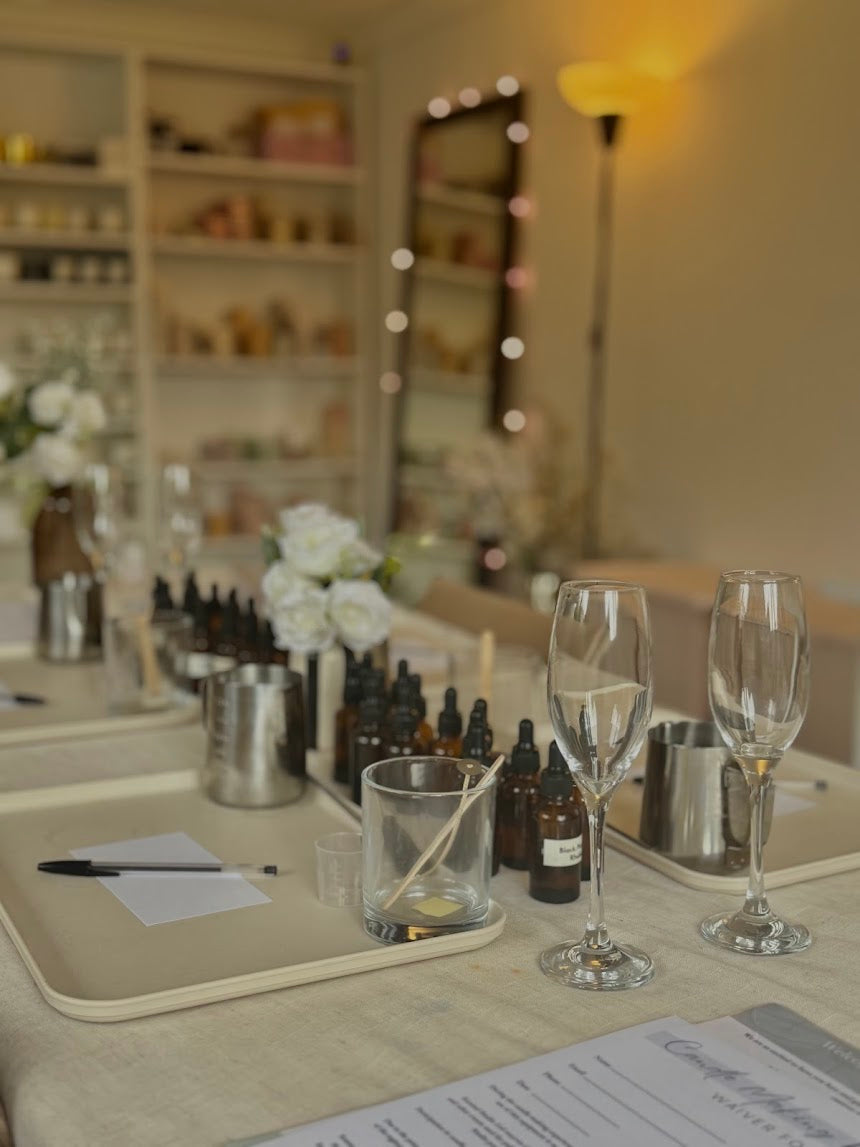Table setup with wine glasses, bottles, and a pen in a blurred interior setting
