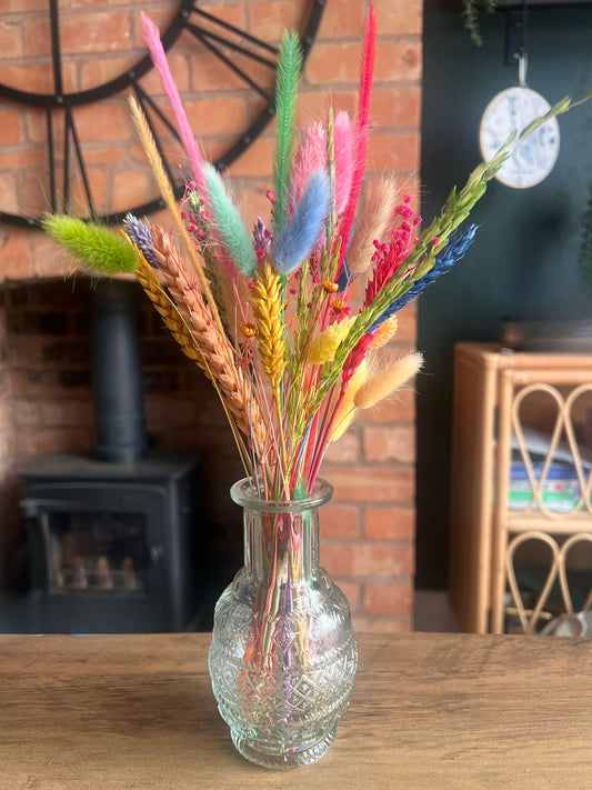 A vase filled with vibrant dried flowers  creating a colorful and lively decorative arrangement.
