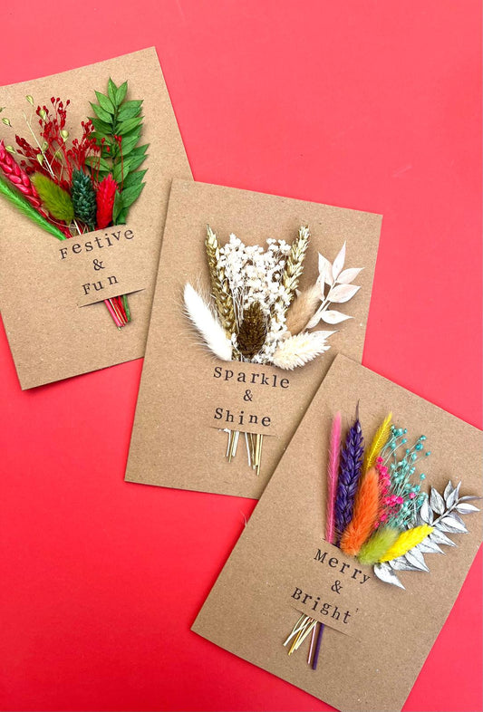 Three decorative greeting cards with floral arrangements on a red background