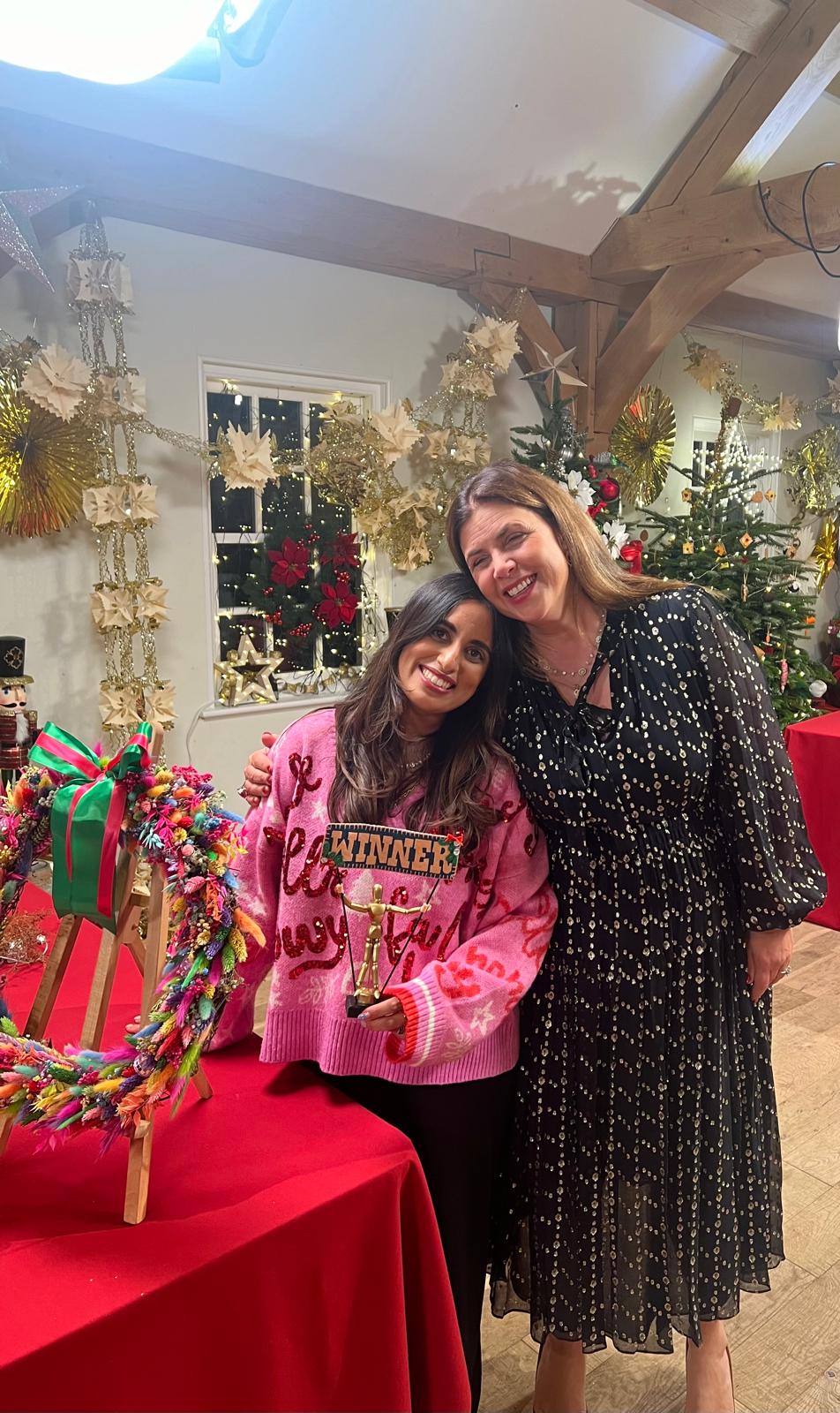 Roo from The Flower Studio by Roo holding the winner's trophy next to Kirstie Allsopp for the award-winning Rainbow Christmas Wreath from Kirstie's Handmade Christmas on Channel 4.