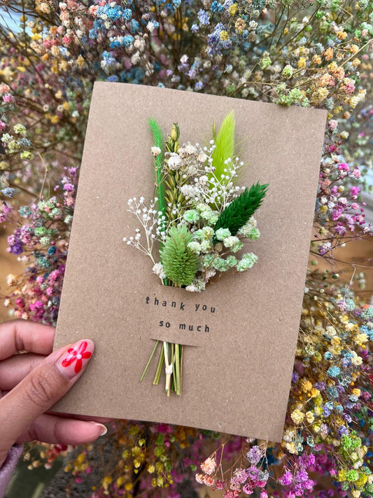 Handmade 'Thank You So Much' card with dried flowers arranged in a removable slot. The flowers can be taken out and placed in a small vase, creating a long-lasting keepsake of appreciation.