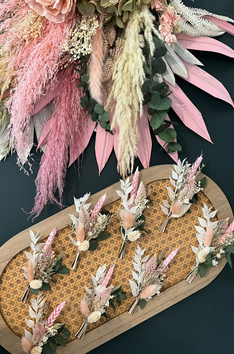 Decorative floral arrangement with pink and green elements on a dark background