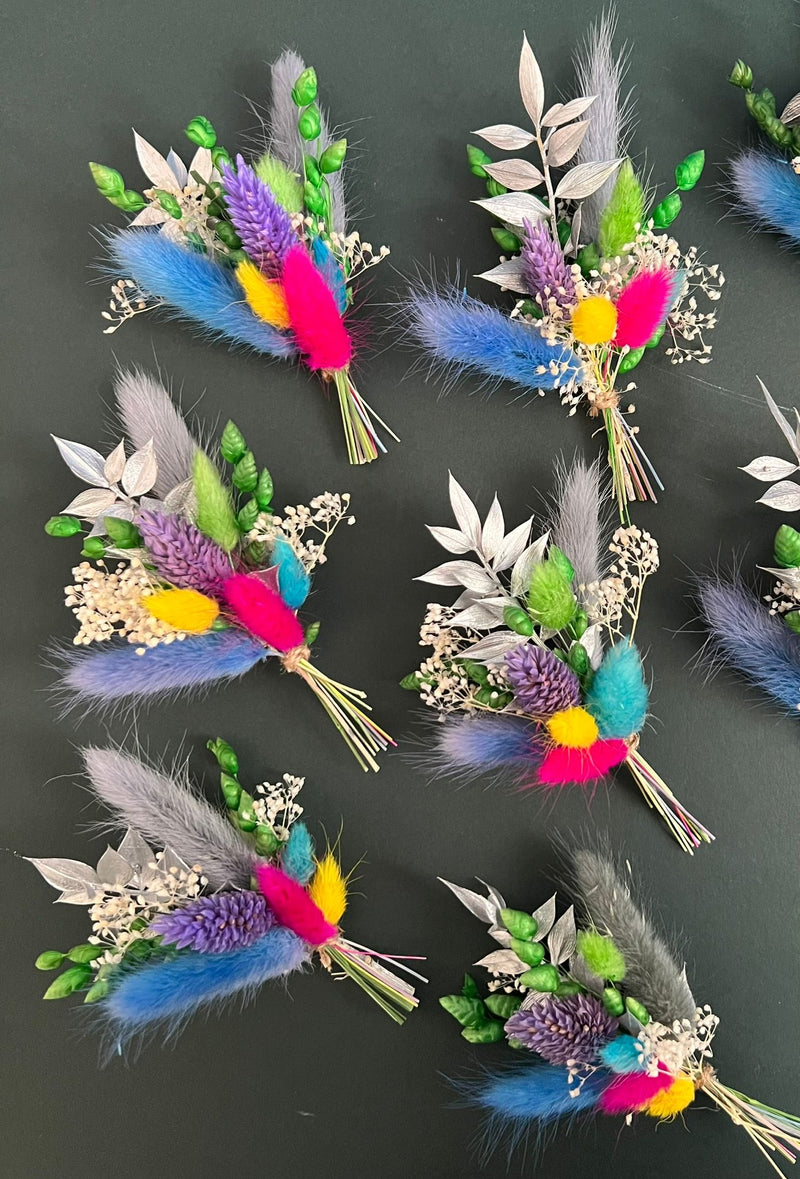 Colorful floral and feather hair clips on a dark background